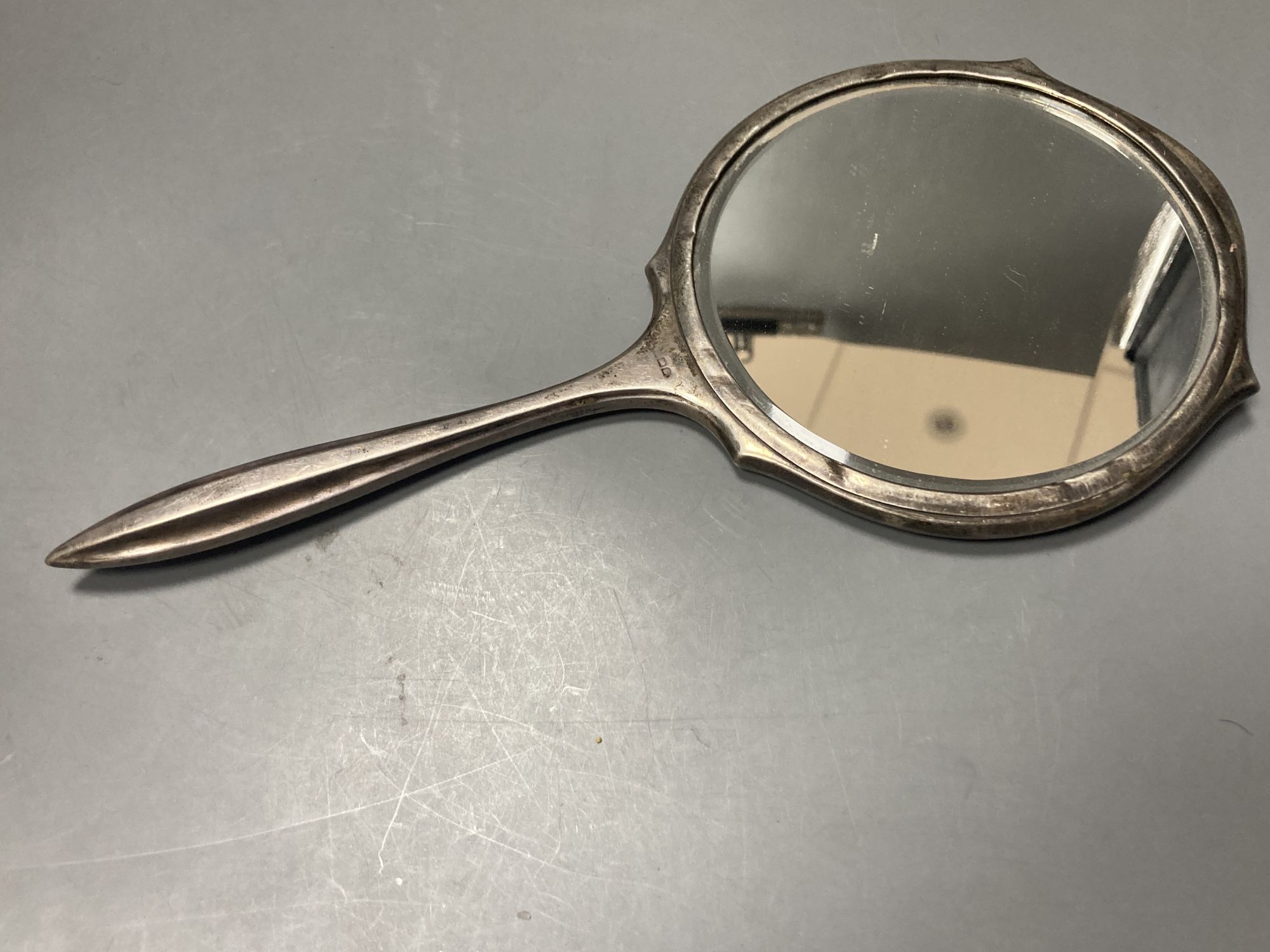 A cased silver handled button hook and shoe horn, a silver and enamel hand mirror, a silver bangle and small silver model ship